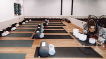Spacious room with yoga mats and a big drum, perfect for qigong practice.