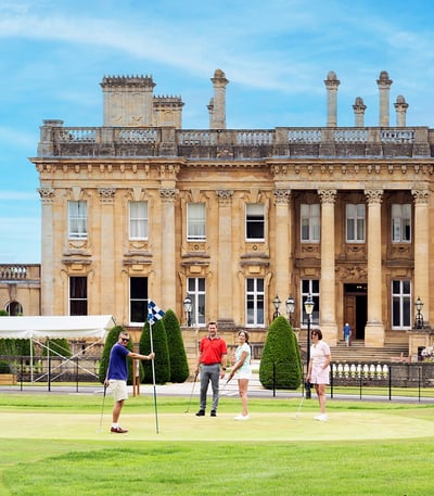 A group of guests playing golf at Heythrop Park.