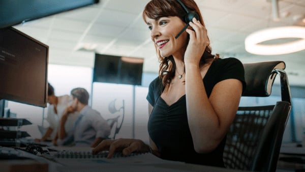 Meet the friendly face of the Warner Hotels contact centre! This image shows a woman wearing a headset, radiating happiness as she assists customers.