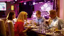 A group of guests in the Grove cabaret restaurant at Alvaston Hall enjoying their meal and waiting for the entertainment to appear on the stage in the background