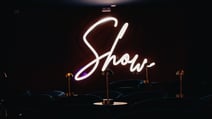 A neon sign saying Show