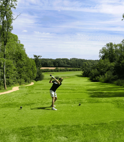 Man taking a swing on the golf course