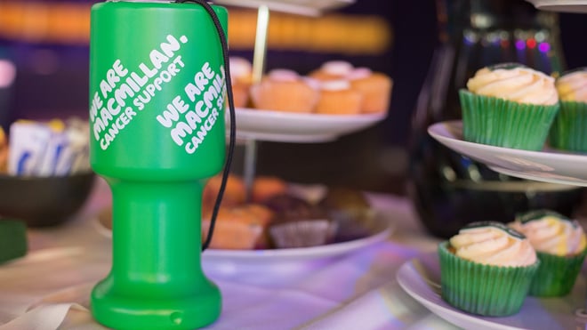 Macmillan collection tin next to Macmillan cakes for Coffee morning fundraising