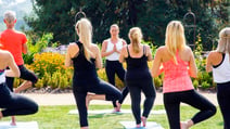 Group of people doing yoga class outside